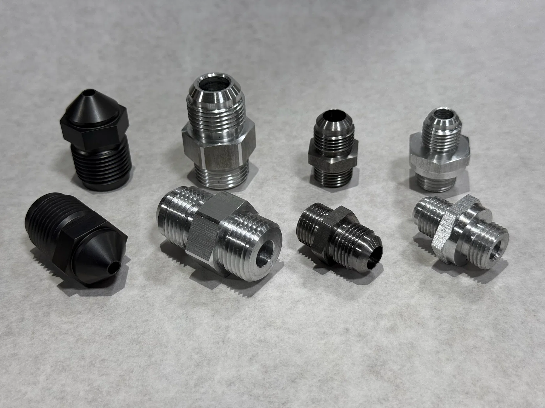 CNC turned threaded components with machined finishes.
