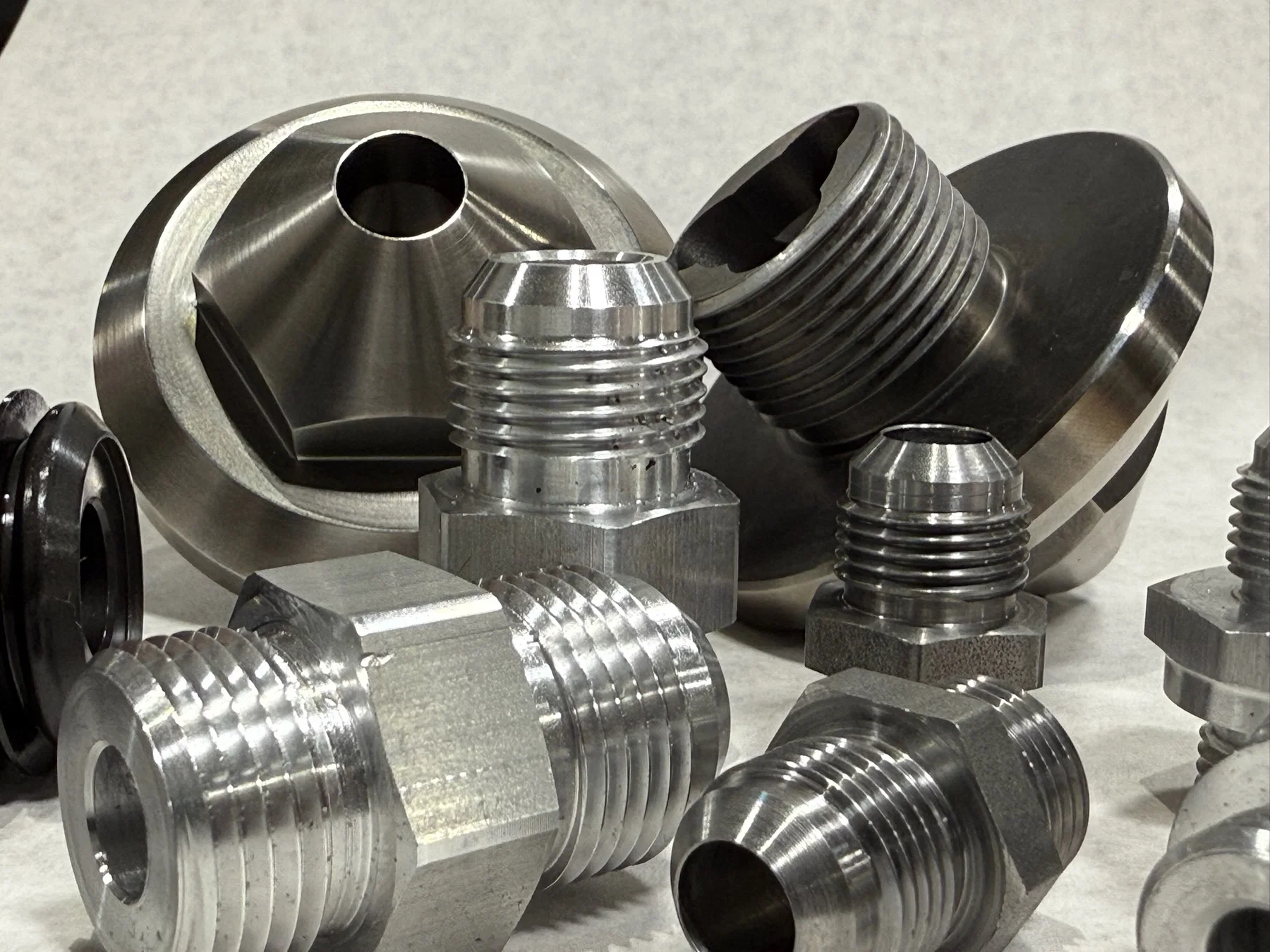 CNC turned threaded components with machined finishes.