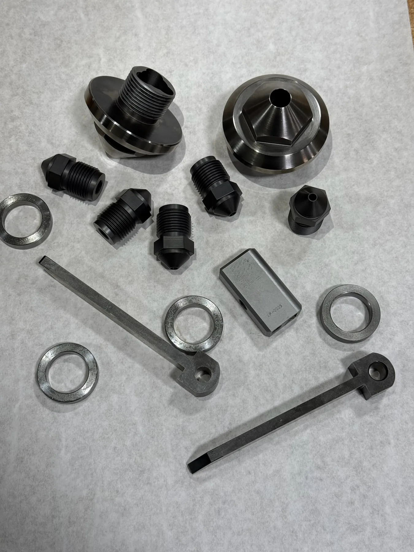 Prototype machined component group with threaded and formed details.