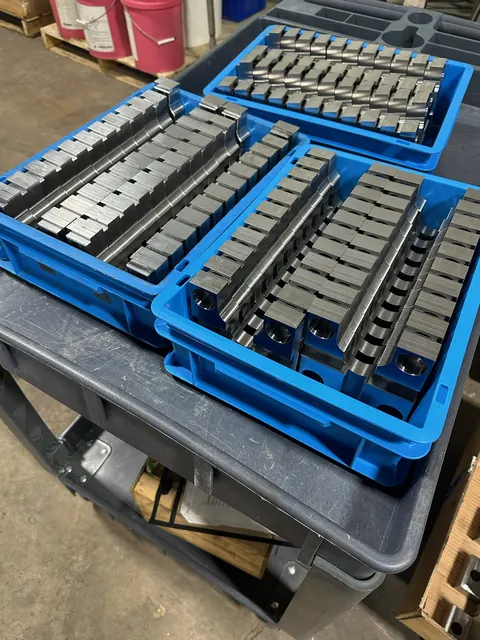 Interchangeable steel stamp characters organized in a tray.