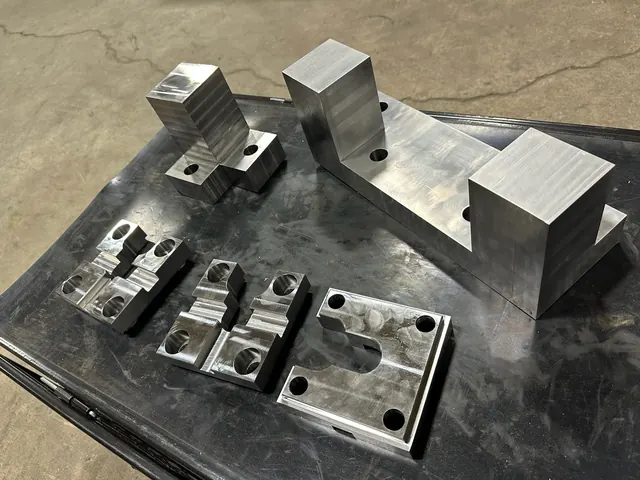 Machined fixture detail with pockets and clamping features.