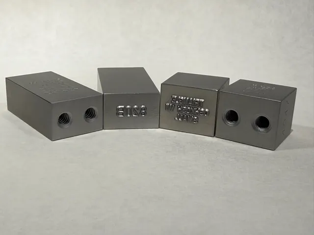 Custom marking die blocks with engraved characters.