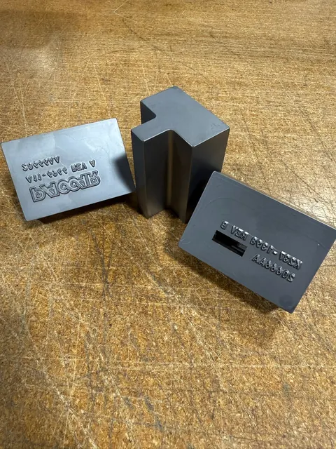 Custom marking tooling blocks on a workbench.