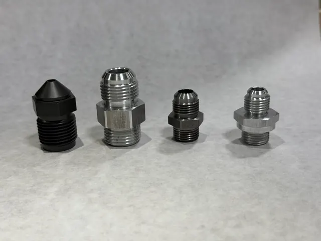 Turned fittings standing upright in mixed finishes.