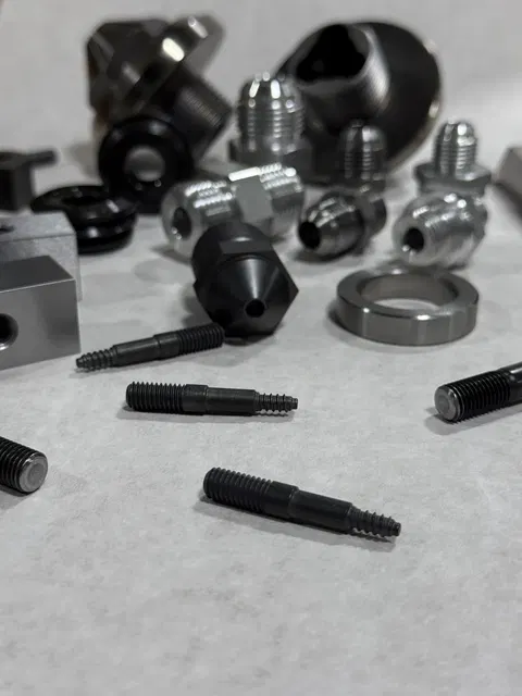 Machined components grouped on a shop bench.