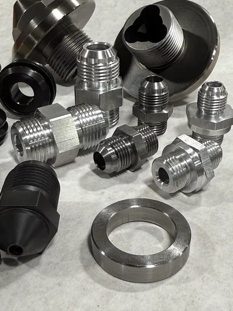 Finished machined components arranged on a work surface.