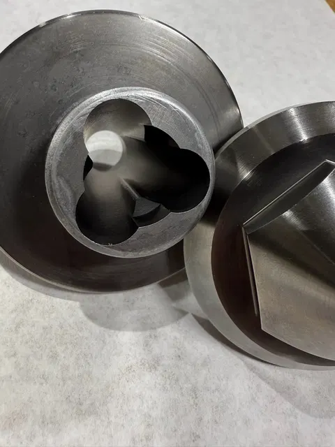 Two machined components with visible internal details.