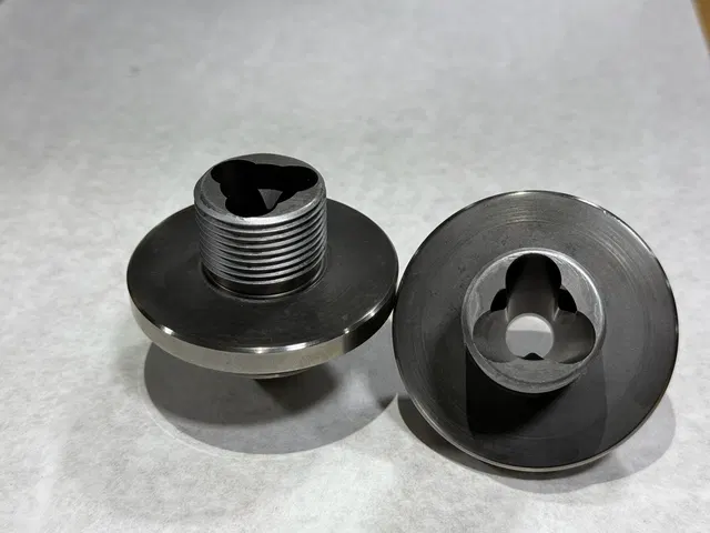 Threaded component pair with machined faces.