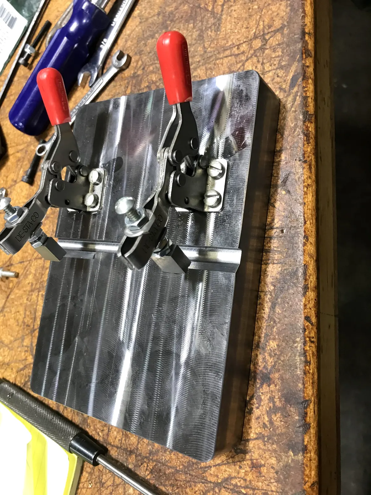 Shop bins with machined and marking components.