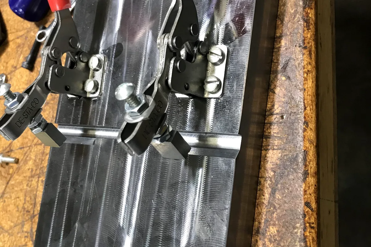 Shop bins with machined and marking components.