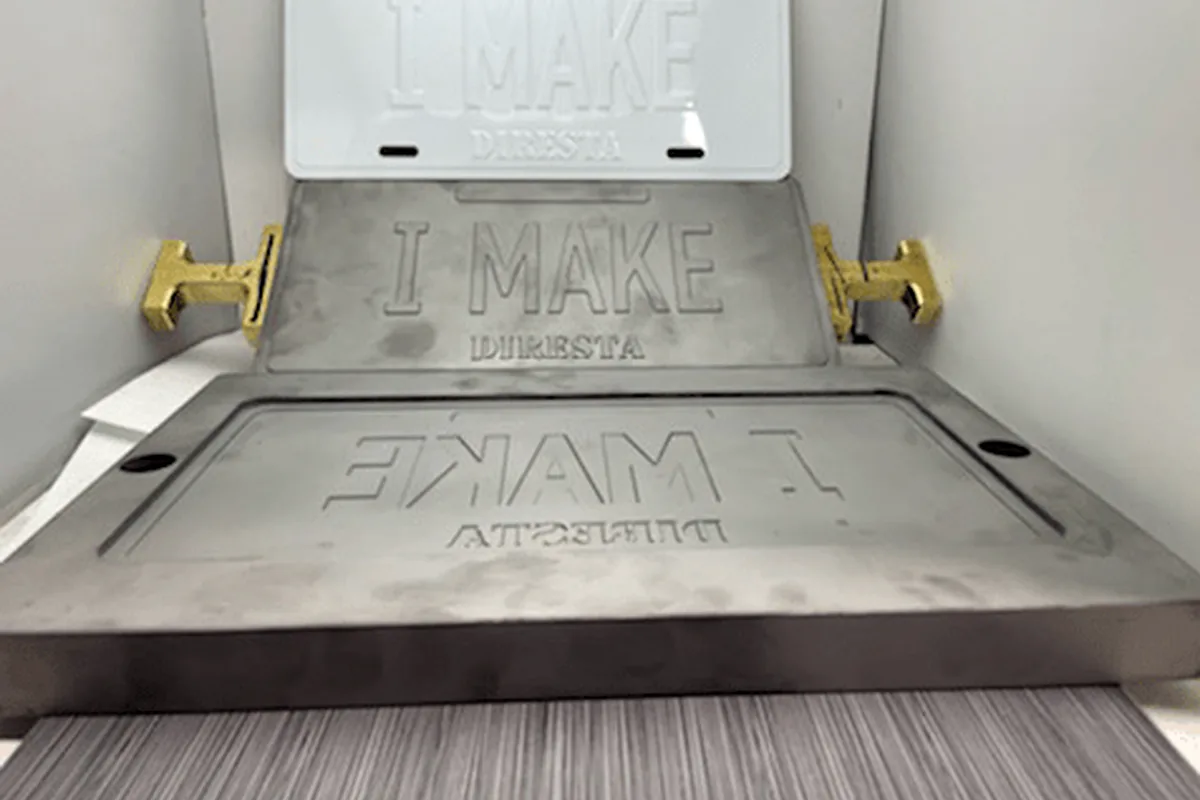 Embossing die and metal plate setup.